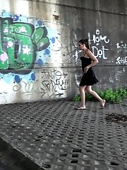 15 pictures - Sexy brunette pisses in the city on drain pipe