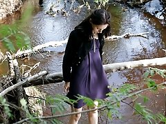 16 pictures - Teenage brunette peeing into a river in the park