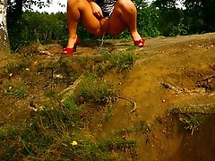 16 pictures - Kinky brunette pissing off a cliff in the woods