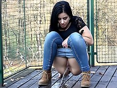 0  - Pretty raven haired girl pisses over the decking