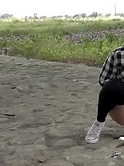 15 pictures - Exotic babe squats to piss near main road