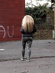 15 pictures - Cute blonde pisses in public in the city
