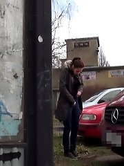 15 pictures - Sexy brunette babe pisses behind a bus stop
