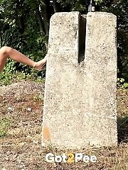 15 pictures - Raven haired babe leans on concrete to piss
