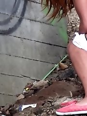 15 pictures - Pretty girl crouches on the soil to pee