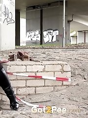 15 pictures - Cute girl in boots pisses outside in the city