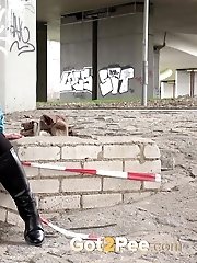 15 pictures - Cute girl in boots pisses outside in the city