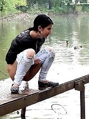 15 pictures - Exotic babe pisses twice in this outdoor scene