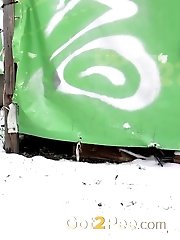 15 pictures - Pretty dark haired girl melts snow as she pees