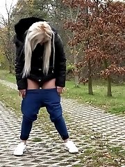 15 pictures - Blonde European pisses on a path on a trail
