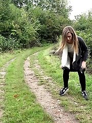 15 pictures - Nervous European girl pisses on grass outside