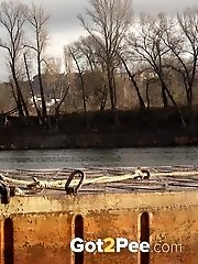 15 pictures - Pretty blonde squatting to pee by the river
