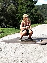 15 pictures - Sexy blonde pisses on a path in a golf course