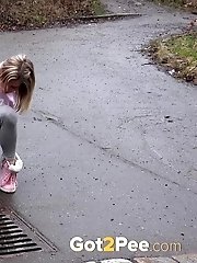 15 pictures - Blonde babe Claudia pisses down a drain outside