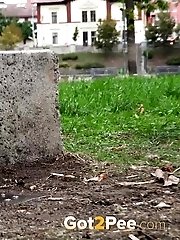 15 pictures - Sitting on a concrete block this brunette pees