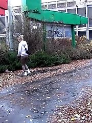 15 pictures - Pretty blonde teen pees in public near buildings