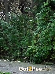 15 pictures - Hot babe pees on a public path while outside