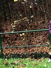 15 pictures - Brunette pisses while standing up next to a road