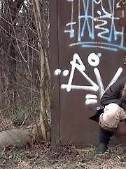 15 pictures - Brunette girl pulls down her trousers to pee outside