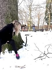 15 pictures - Cute blonde pisses in the snow outside